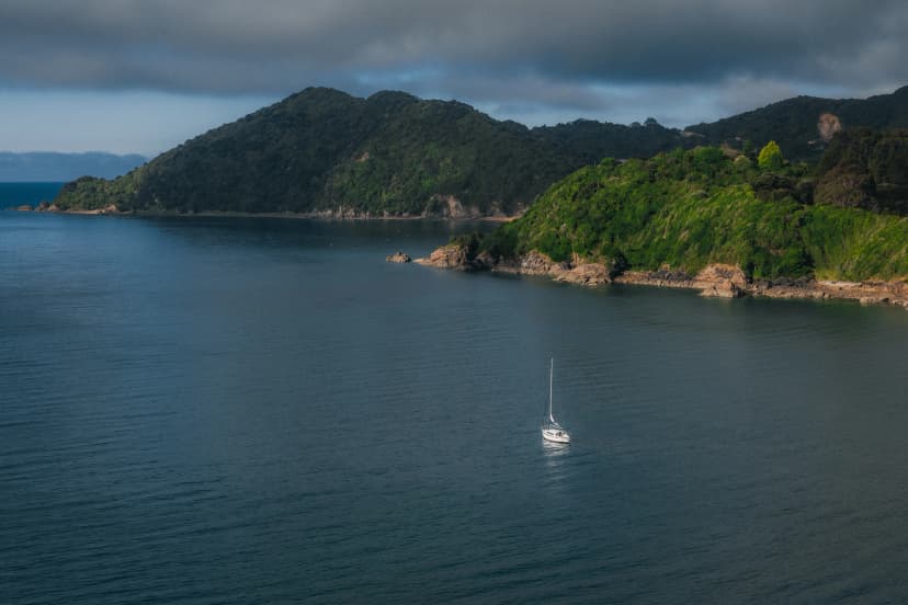 A small boat in a rocky cove in New Zealand.