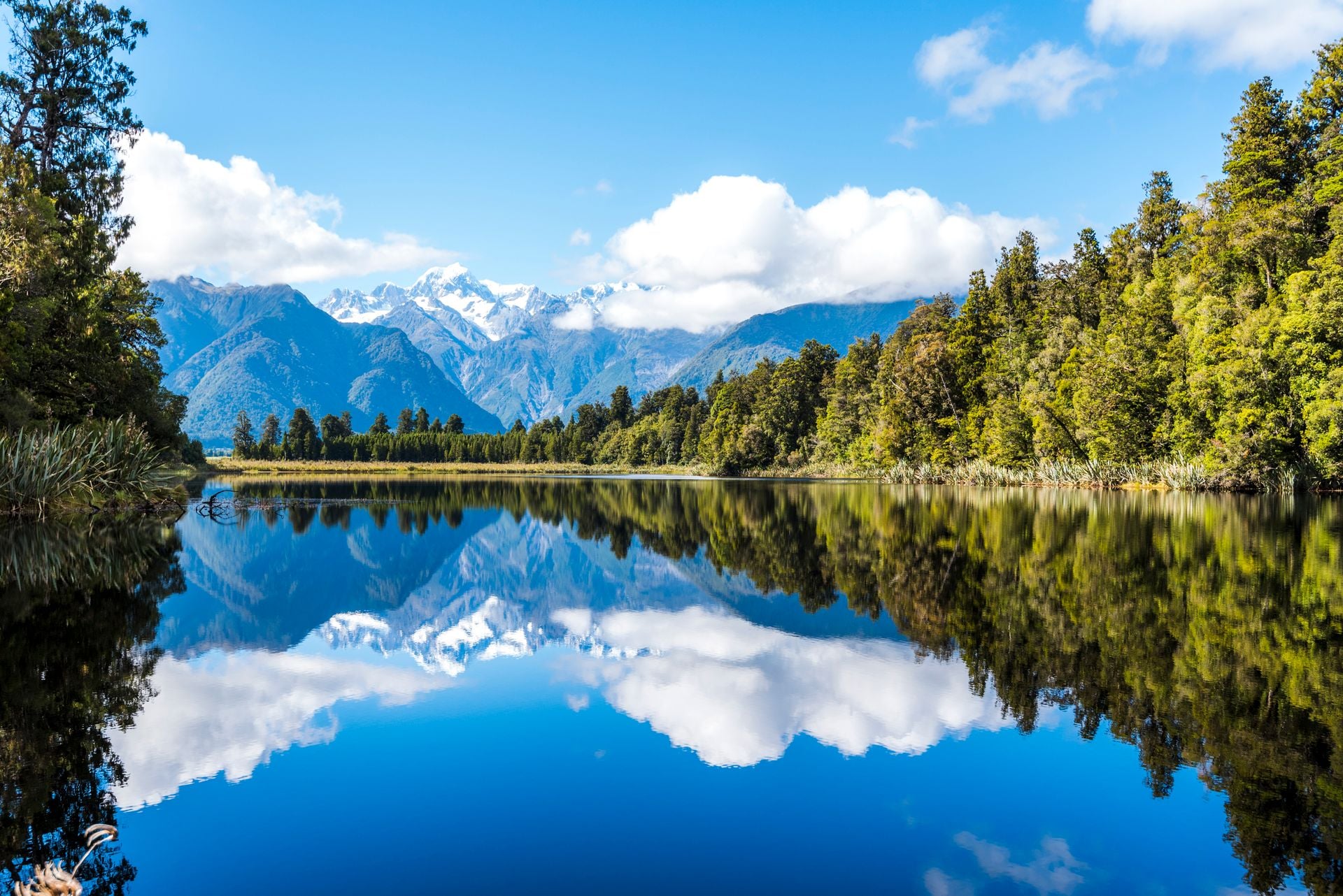 Get to Lake Matheson at dawn, before the wind ruffles it